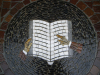 Table with mosaic design of a book