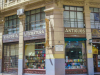 A photograph of a building occupying the corner of a busy city street