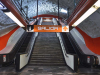 An escalator rising up out of the frame. A sign above reads: Salida.