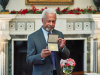 A photograph of Abdulrazak Gurnah holding up his recently awarded medal from the Nobel committee