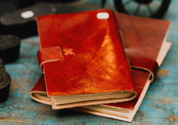 A photograph of two leather bound journals in a pile