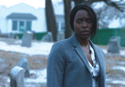 A woman in a blue suit looks just off-panel with a snowy suburban scene behind her